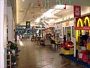 [ Prince Kuhio Shopping Center, the only mall in Hilo, and a struggling one at that. Empty storefronts galore, and two car dealerships are now tenants. ]